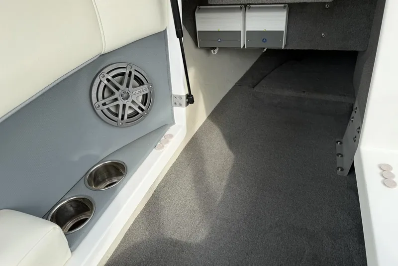 Slide: The Image of Interior of a 2016 Cobalt 220 boat featuring speaker and cup holders. - 24