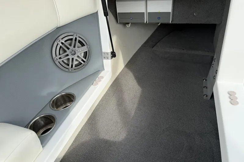 Slide: The Image of Interior of a 2016 Cobalt 220 boat featuring speaker and cup holders. - 25