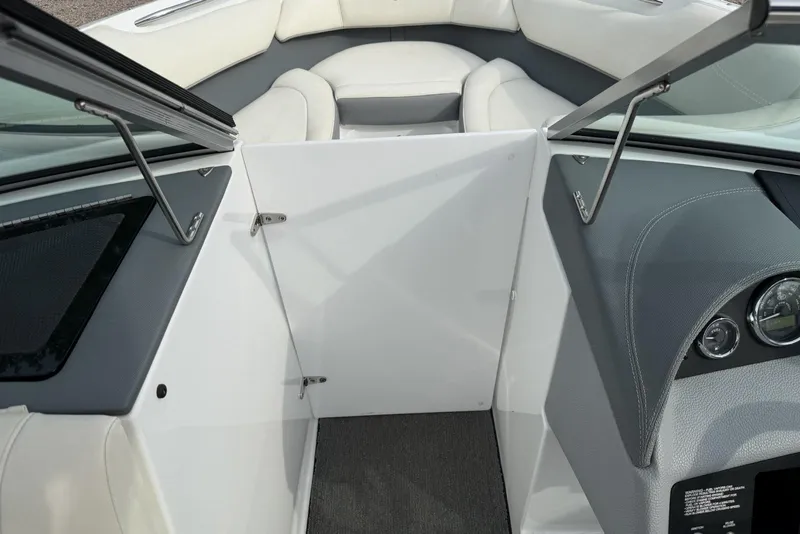 Slide: The Image of Interior view of a 2016 Cobalt 220 boat, featuring sleek seating and dashboard design. - 26