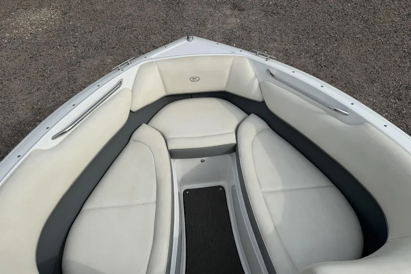 Slide: The Image of 2016 Cobalt 220 boat interior with white and gray cushioned seating. - 27