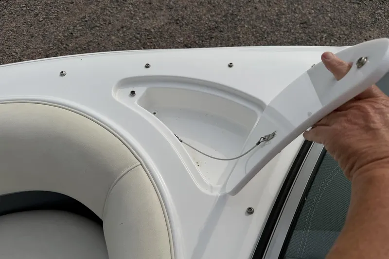 Slide: The Image of Open storage compartment on a 2016 Cobalt 220 boat, showing interior details. - 28