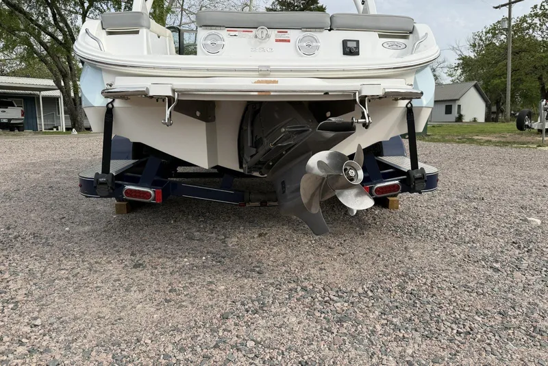 Slide: The Image of Rear view of a 2016 Cobalt 220 boat on a trailer, showing propeller and stern. - 3