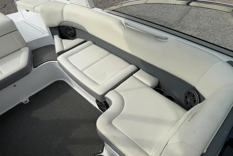 Slide: The Image of Interior seating of a 2016 Cobalt 220 boat with white upholstery and speakers. - 30