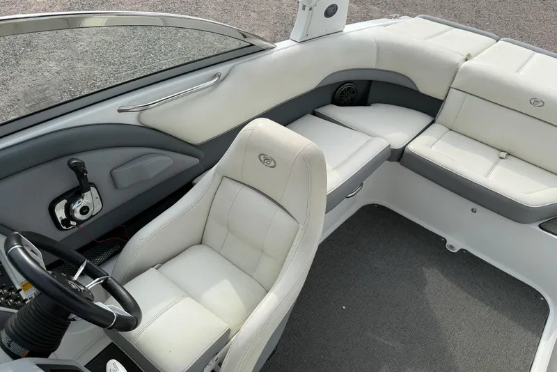 Slide: The Image of Interior of a 2016 Cobalt 220 boat with white leather seating and steering wheel. - 31