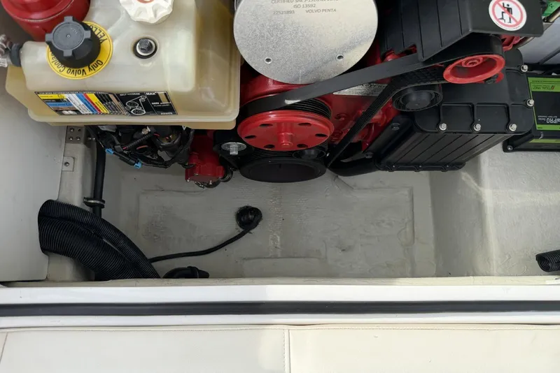 Slide: The Image of Engine compartment of a 2016 Cobalt 220 boat, featuring a Volvo Penta engine. - 35