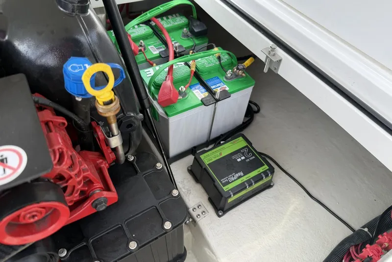 Slide: The Image of Engine compartment of a 2016 Cobalt 220 boat with batteries and charger. - 36