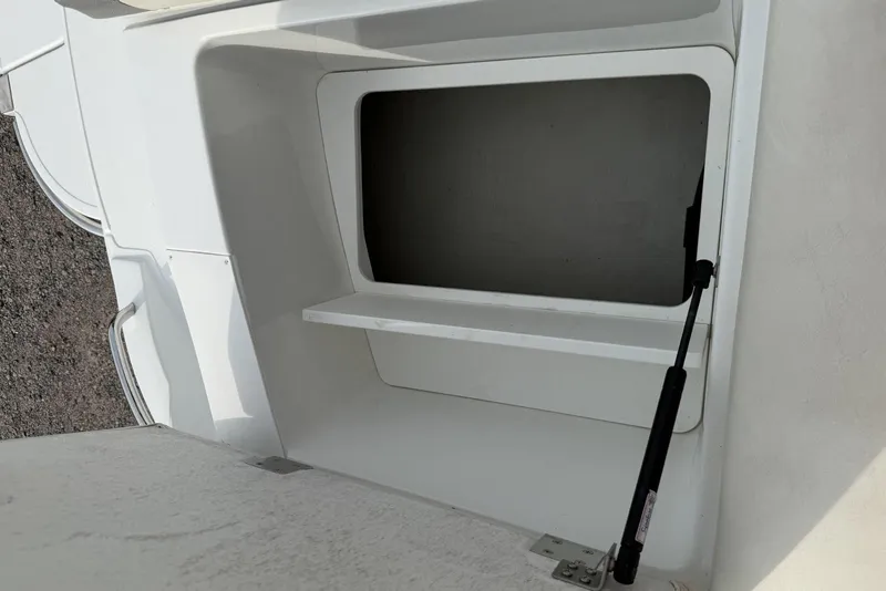 Slide: The Image of Open storage compartment on a 2016 Cobalt 220 boat. - 37