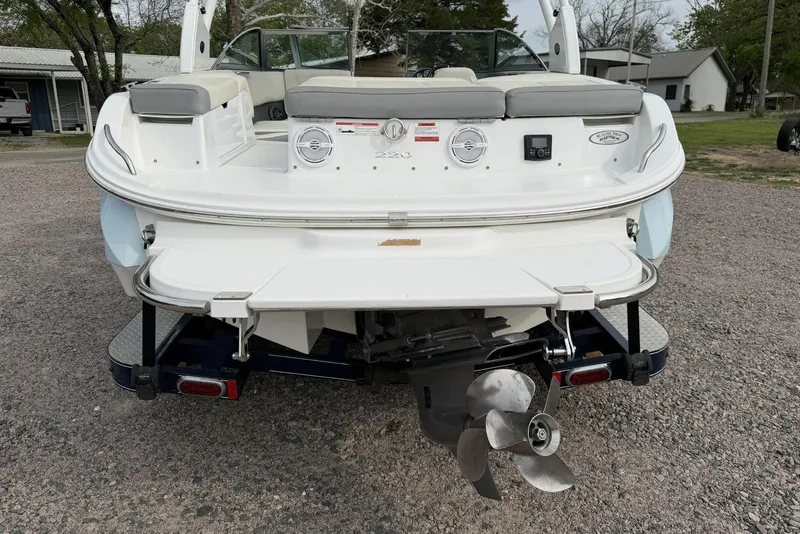 Slide: The Image of Rear view of a 2016 Cobalt 220 boat with visible propeller and seating. - 4