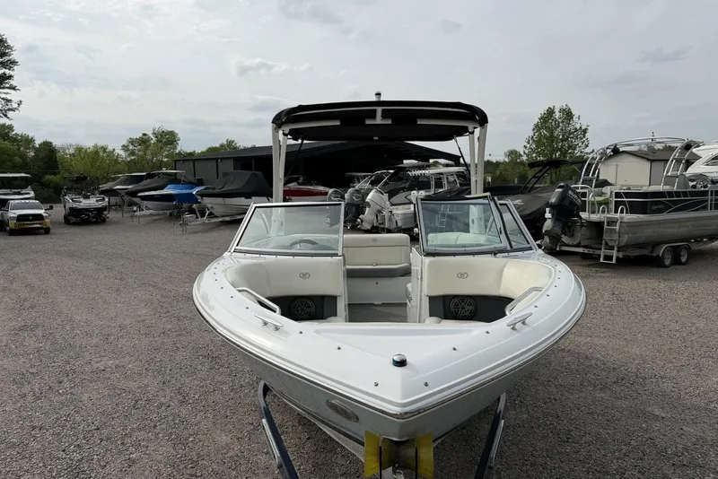 Slide: The Image of 2016 Cobalt 220 boat displayed in a marina with other vessels. - 7