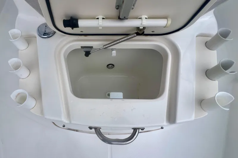 Slide: The Image of 2008 Boston Whaler 200 Dauntless boat storage compartment with rod holders. - 10