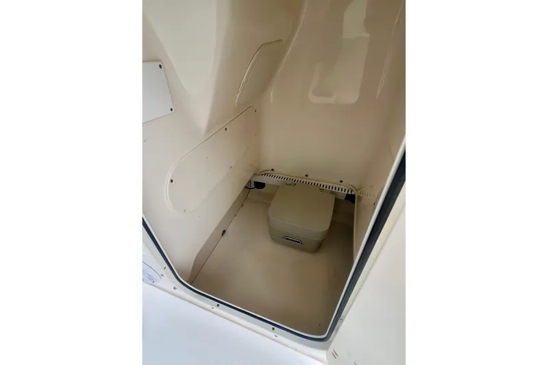 Slide: The Image of 2008 Boston Whaler 200 Dauntless interior storage compartment with portable toilet. - 12