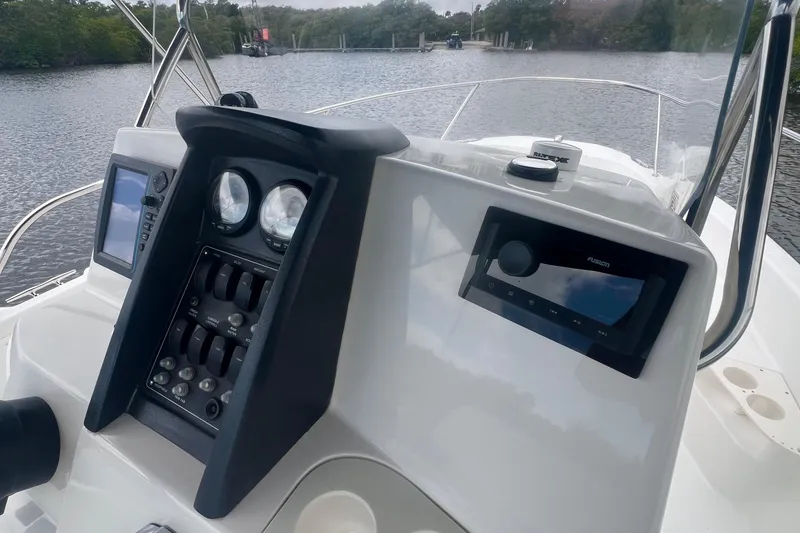 Slide: The Image of 2008 Boston Whaler 200 Dauntless boat dashboard with navigation and control panels. - 5