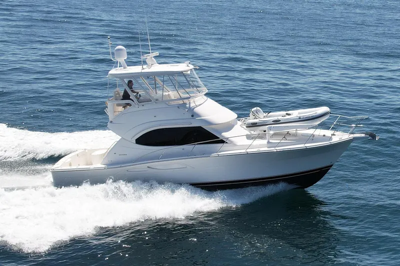 Slide: The Image of 2003 Riviera 40 Flybridge yacht cruising on open water. - 1