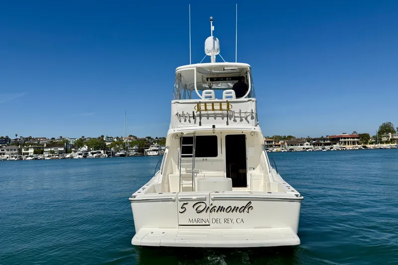 Slide: The Image of 2003 Riviera 40 Flybridge yacht on water, Marina del Rey, clear blue sky. - 10