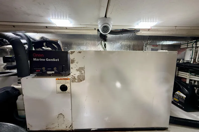Slide: The Image of Engine room of 2003 Riviera 40 Flybridge with Onan Marine GenSet and security camera. - 101