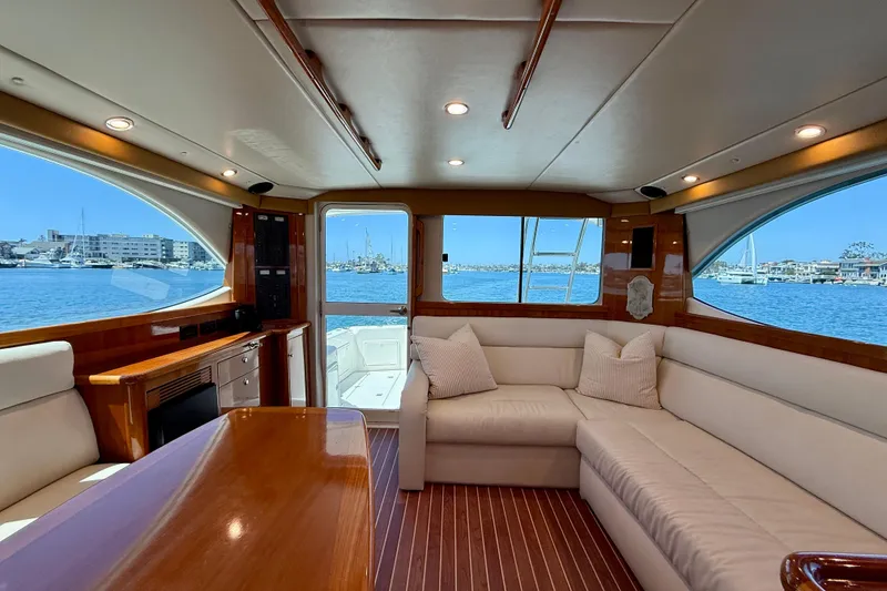 Slide: The Image of Luxurious interior of 2003 Riviera 40 Flybridge yacht with waterfront view. - 13