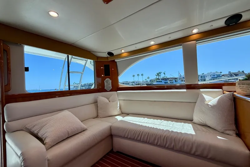 Slide: The Image of Luxurious interior of 2003 Riviera 40 Flybridge yacht with plush seating and scenic views. - 14
