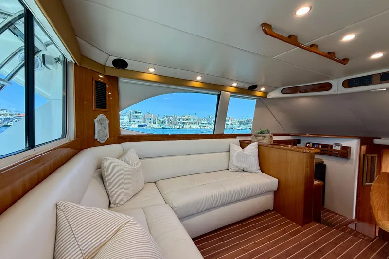 Slide: The Image of Luxurious interior of 2003 Riviera 40 Flybridge yacht with plush seating and scenic window view. - 15