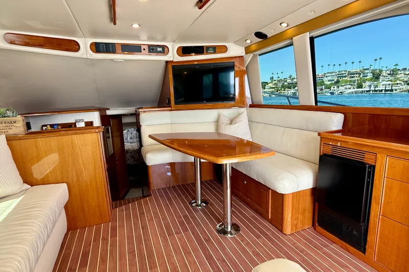 Slide: The Image of Luxurious interior of 2003 Riviera 40 Flybridge yacht with wood accents and waterfront view. - 16