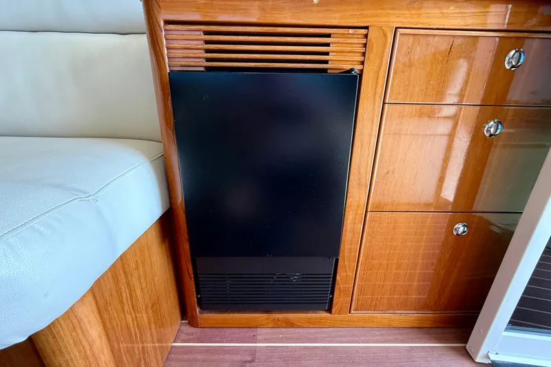 Slide: The Image of Interior of 2003 Riviera 40 Flybridge yacht with wooden cabinetry and black appliance. - 17