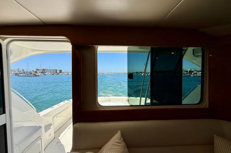 Slide: The Image of Interior view from a 2003 Riviera 40 Flybridge yacht, overlooking a serene marina. - 18