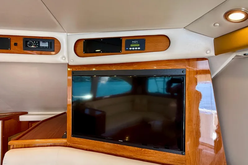 Slide: The Image of Interior of 2003 Riviera 40 Flybridge yacht with TV and control panels. - 20