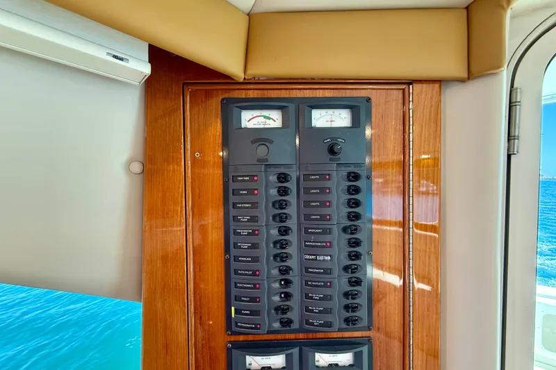 Slide: The Image of Electrical panel on a 2003 Riviera 40 Flybridge yacht, featuring various switches and gauges. - 21