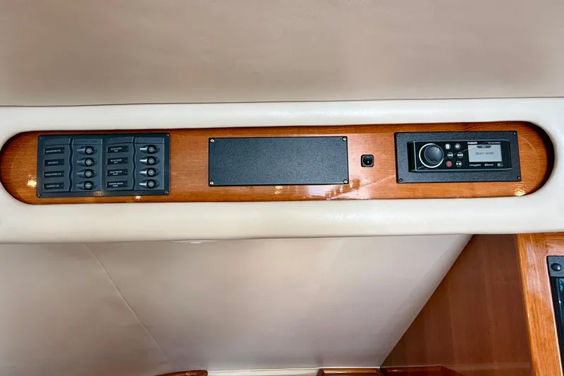 Slide: The Image of Control panel of a 2003 Riviera 40 Flybridge yacht with switches and audio system. - 23