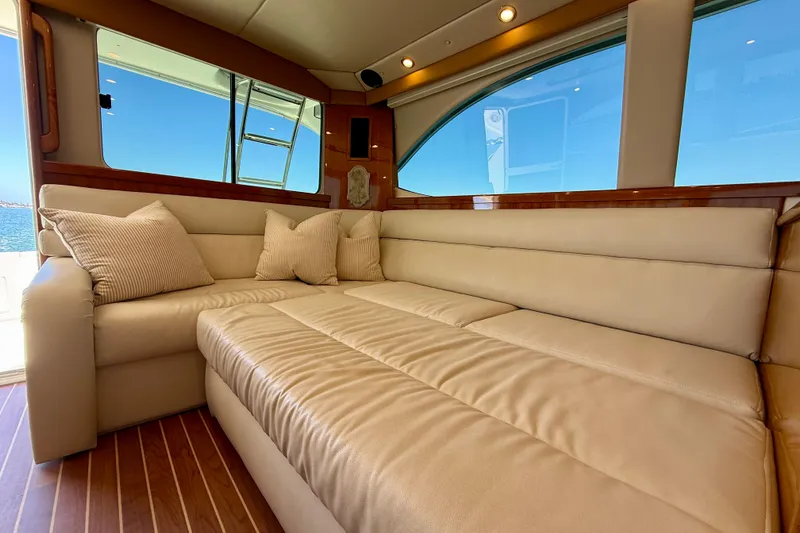 Slide: The Image of Luxurious interior of 2003 Riviera 40 Flybridge yacht with plush beige seating. - 25