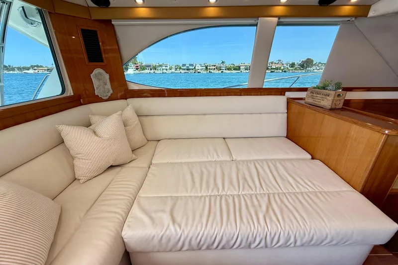 Slide: The Image of Luxurious interior of 2003 Riviera 40 Flybridge yacht with plush seating and scenic window view. - 26