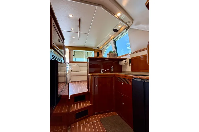 Slide: The Image of Luxurious interior of 2003 Riviera 40 Flybridge yacht with wooden cabinetry and modern amenities. - 28