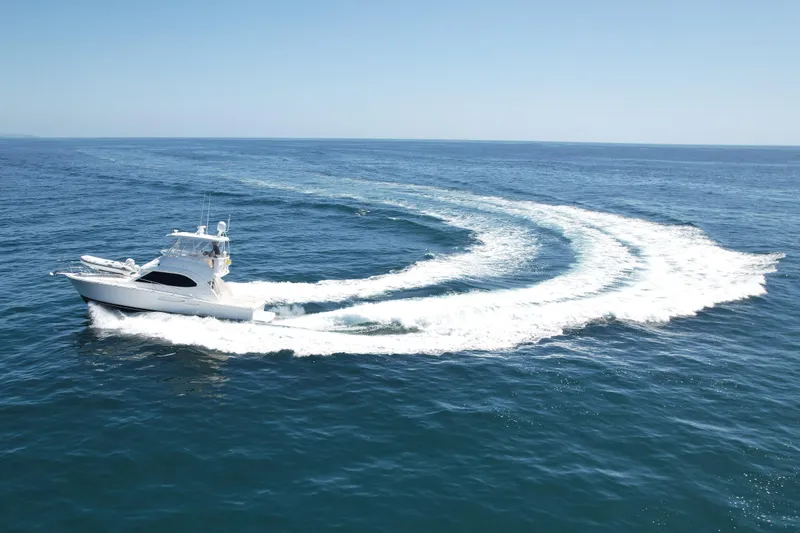 Slide: The Image of 2003 Riviera 40 Flybridge yacht cruising on open ocean waters. - 3