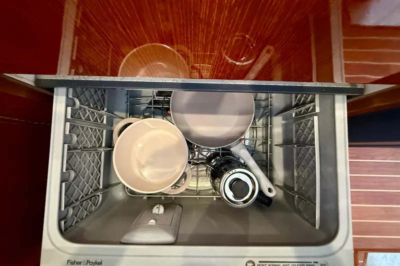 Slide: The Image of Open dishwasher with dishes inside on a 2003 Riviera 40 Flybridge yacht. - 32