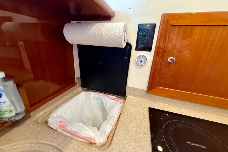 Slide: The Image of Interior of 2003 Riviera 40 Flybridge kitchen with paper towel holder and induction cooktop. - 34