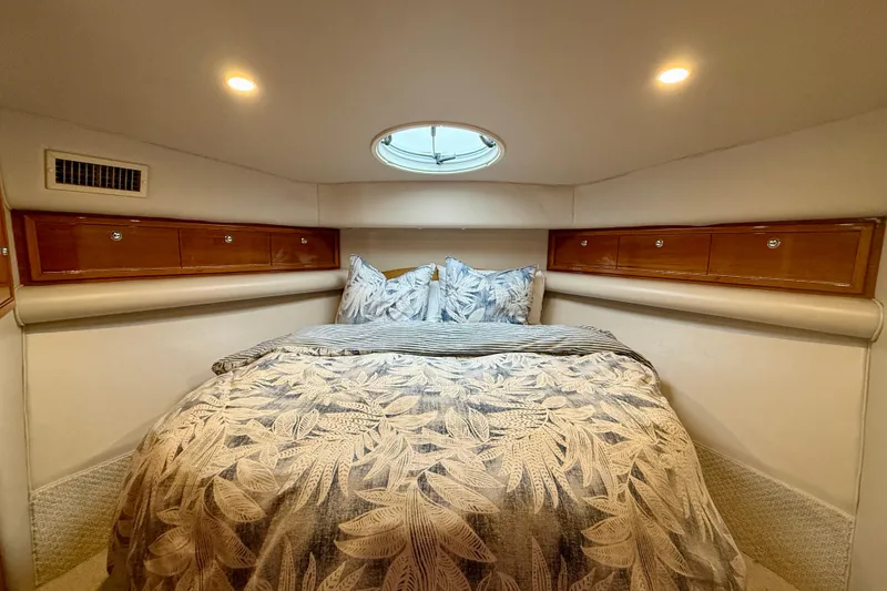 Slide: The Image of Luxurious bedroom interior of 2003 Riviera 40 Flybridge yacht with elegant bedding and wood accents. - 36