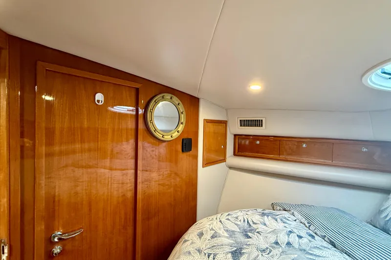 Slide: The Image of Interior cabin of 2003 Riviera 40 Flybridge yacht with wooden door and porthole. - 37