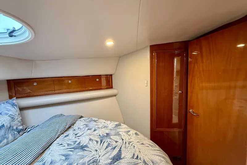 Slide: The Image of Luxurious cabin interior of 2003 Riviera 40 Flybridge yacht with elegant wood finishes. - 38