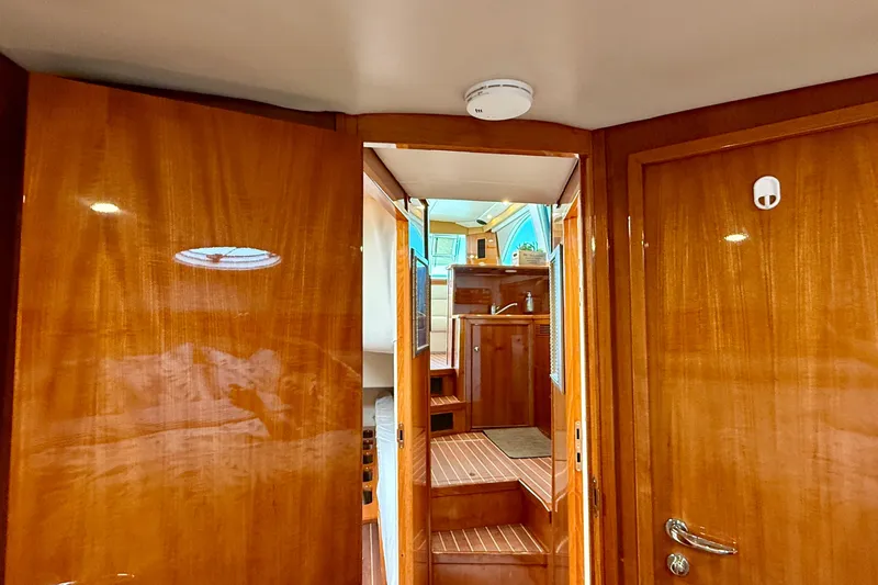 Slide: The Image of Interior of 2003 Riviera 40 Flybridge yacht with polished wood finish and stairs. - 39