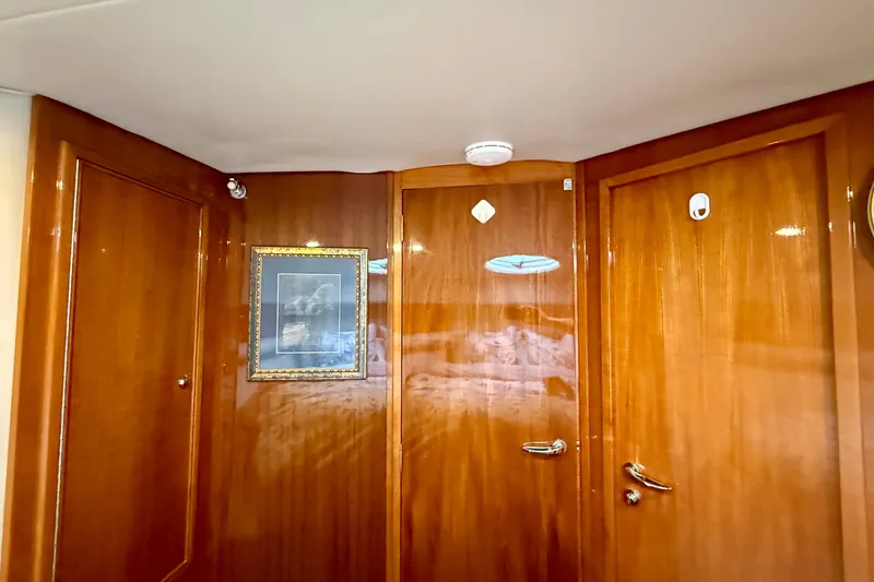 Slide: The Image of Interior of 2003 Riviera 40 Flybridge with polished wood paneling and framed artwork. - 40