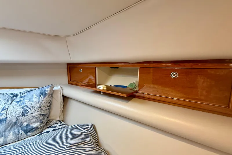 Slide: The Image of Interior of 2003 Riviera 40 Flybridge with wooden storage and decorative pillows. - 41