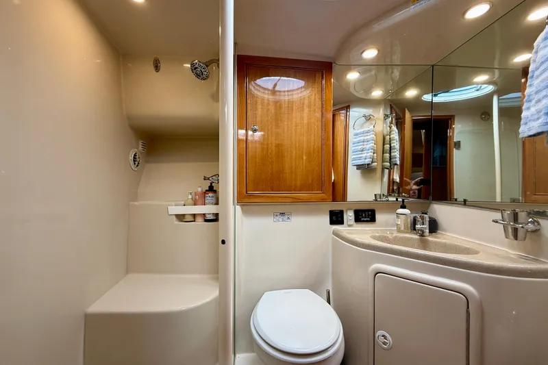 Slide: The Image of Luxurious bathroom in 2003 Riviera 40 Flybridge yacht with shower, toilet, and vanity. - 44