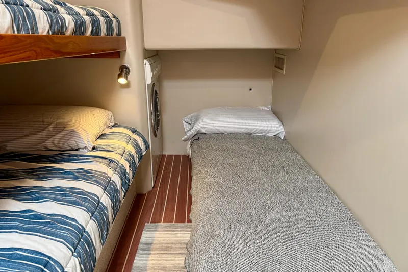 Slide: The Image of 2003 Riviera 40 Flybridge cabin with bunk beds and washing machine. - 50