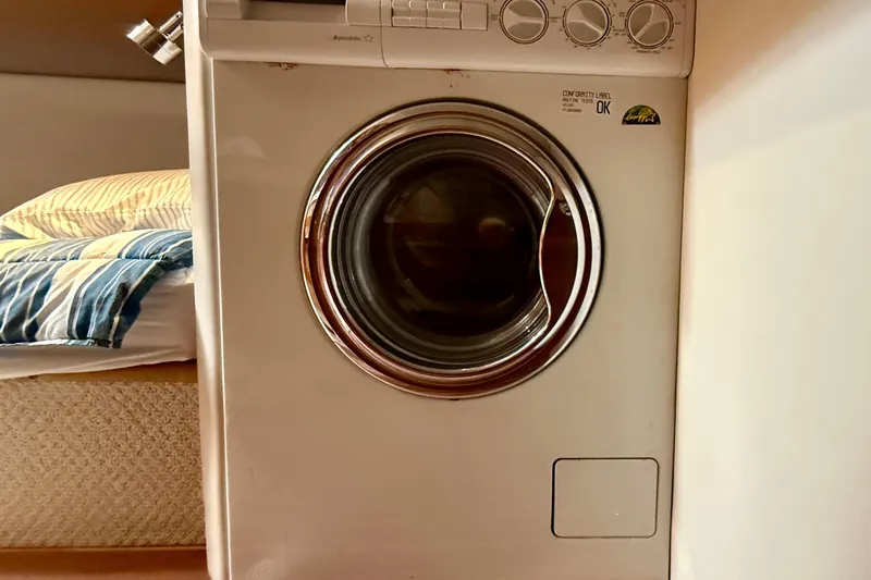 Slide: The Image of Washing machine inside 2003 Riviera 40 Flybridge yacht cabin. - 52