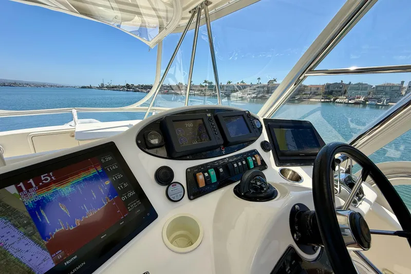 Slide: The Image of Helm of 2003 Riviera 40 Flybridge yacht with navigation equipment and ocean view. - 55