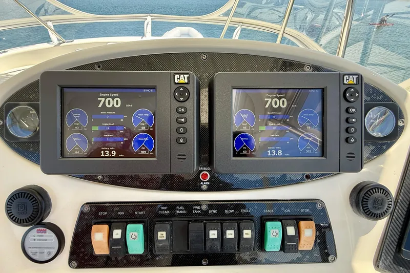 Slide: The Image of Control panel of a 2003 Riviera 40 Flybridge boat with dual engine displays. - 56