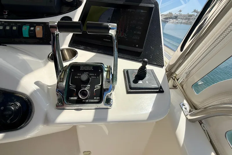 Slide: The Image of Control panel of a 2003 Riviera 40 Flybridge yacht with throttle and navigation display. - 57