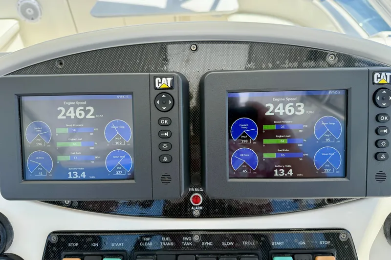 Slide: The Image of Dual engine displays on a 2003 Riviera 40 Flybridge showing RPM and engine metrics. - 60