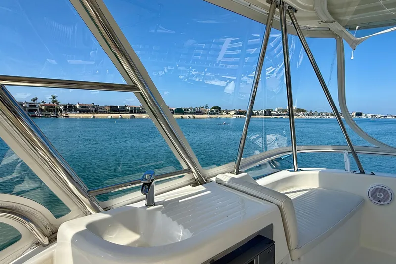 Slide: The Image of Interior view from a 2003 Riviera 40 Flybridge yacht overlooking a serene waterfront. - 63