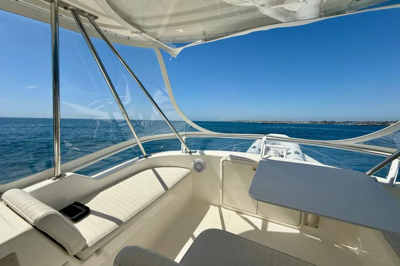 Slide: The Image of Flybridge view from 2003 Riviera 40, showcasing ocean horizon and clear blue skies. - 64