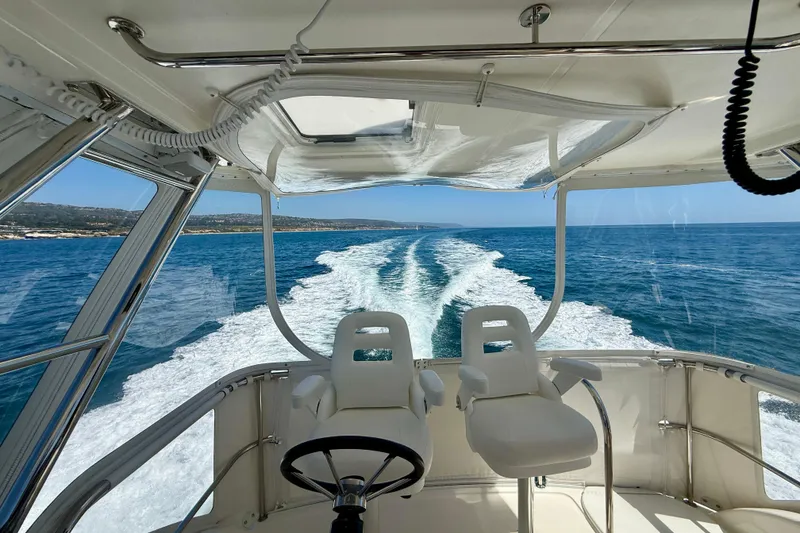 Slide: The Image of 2003 Riviera 40 Flybridge yacht cruising on open sea, view from helm. - 66
